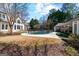 Expansive backyard featuring a pool, mature trees, and lush landscaping at 610 Graystone Ct, Peachtree City, GA 30269