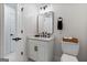 Powder room features a modern vanity with matte black fixtures, a large mirror, and a toilet with a basket at 610 Graystone Ct, Peachtree City, GA 30269