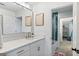 Bright bathroom features a large mirror, white vanity, and shower with blue tile accent, plus an adjoining room at 610 Graystone Ct, Peachtree City, GA 30269