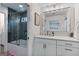 Bathroom features a modern vanity with sleek fixtures, an enclosed shower with black tiling, and ample lighting at 610 Graystone Ct, Peachtree City, GA 30269