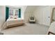 Cozy bedroom showcases natural light, a comfortable bed, and stylish decor, complete with chair and neutral carpet at 610 Graystone Ct, Peachtree City, GA 30269