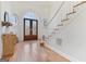 Bright foyer featuring hardwood floors, a staircase, decorative entry doors, and light-filled entry at 610 Graystone Ct, Peachtree City, GA 30269