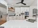 Bright kitchen featuring white cabinetry, a stainless steel refrigerator, and a gas cooktop at 610 Graystone Ct, Peachtree City, GA 30269