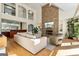 Inviting living room features a stone fireplace, hardwood floors, soaring ceilings, and elegant decor at 610 Graystone Ct, Peachtree City, GA 30269