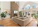 Spacious living room featuring a stone fireplace, hardwood floors, high ceilings, and abundant natural light at 610 Graystone Ct, Peachtree City, GA 30269
