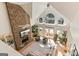 Spacious living room boasts vaulted ceilings, a stone fireplace, a ceiling fan, and large windows with a view at 610 Graystone Ct, Peachtree City, GA 30269