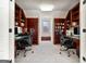 Home office with built-in bookshelves, desk space on each side and a window providing natural light at 610 Graystone Ct, Peachtree City, GA 30269