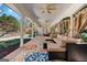Covered patio with plush seating, ceiling fans and views of the backyard at 610 Graystone Ct, Peachtree City, GA 30269