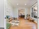 A bright playroom with hardwood floors, a rug, and -sized furniture and a view into the Dining Room at 610 Graystone Ct, Peachtree City, GA 30269