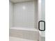 Tiled walk-in shower with glass door and built-in bench, offering a clean and modern design at 610 Graystone Ct, Peachtree City, GA 30269