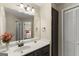 Bathroom vanity with a spacious countertop, decorative mirror, and ample storage space at 402 Mill Pond Rd # 402, Roswell, GA 30076