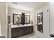 Bathroom with double vanity, dark cabinets, tile floors, two mirrors and neutral walls at 402 Mill Pond Rd # 402, Roswell, GA 30076
