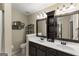 Bathroom with dual sinks, modern fixtures, dark wood cabinets, and decorative mirrors at 402 Mill Pond Rd # 402, Roswell, GA 30076