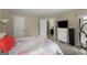 Bedroom featuring a bed, a view into the bathroom, and an exercise machine at 402 Mill Pond Rd # 402, Roswell, GA 30076