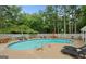 Inviting community pool area featuring lounge chairs, tables, and a fenced perimeter, perfect for relaxation and recreation at 402 Mill Pond Rd # 402, Roswell, GA 30076