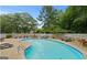 Inviting community pool area featuring lounge chairs, tables, and a fenced perimeter, perfect for relaxation and recreation at 402 Mill Pond Rd # 402, Roswell, GA 30076