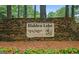 Stone sign for Hidden Lake community with colorful flowers in foreground, offering private residences by the water at 402 Mill Pond Rd # 402, Roswell, GA 30076
