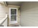Unit 402 entrance features security door, stylish light fixture, and muted-tone siding at 402 Mill Pond Rd # 402, Roswell, GA 30076