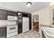 Kitchen with white appliances and cabinets, tile floors and countertops, and a view to dining at 402 Mill Pond Rd # 402, Roswell, GA 30076