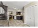 Kitchen with white appliances, dark cabinets, tile floors and counters, and laundry closet at 402 Mill Pond Rd # 402, Roswell, GA 30076