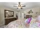 Main bedroom with ceiling fan, neutral walls and carpet, and view to ensuite bathroom at 402 Mill Pond Rd # 402, Roswell, GA 30076