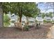 Picturesque community seating area by the lake, featuring benches and tables, creating a relaxing ambiance at 402 Mill Pond Rd, Roswell, GA 30076