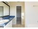 Bathroom featuring a blue granite countertop and black framed mirror at 2536 Lancewood Ln, Lithonia, GA 30058