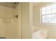 This bathroom features a shower and bathtub combination with a window at 2536 Lancewood Ln, Lithonia, GA 30058