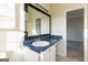 Bathroom featuring a granite countertop and black framed mirror and natural light at 2536 Lancewood Ln, Lithonia, GA 30058
