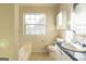 Bathroom featuring a shower-tub combo, window, toilet and vanity at 2536 Lancewood Ln, Lithonia, GA 30058