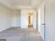Bedroom with large window and multiple doors and light colored carpet at 2536 Lancewood Ln, Lithonia, GA 30058