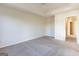 Bedroom with large window, tray ceiling, and light colored carpet at 2536 Lancewood Ln, Lithonia, GA 30058