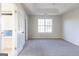 Bedroom featuring a large window, ensuite bathroom, and light colored carpet at 2536 Lancewood Ln, Lithonia, GA 30058