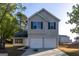 Charming two-story home with a two-car garage, green shutters, and a well-maintained front yard at 2536 Lancewood Ln, Lithonia, GA 30058