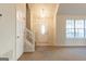 Inviting foyer featuring a staircase, front door, and natural light from a window at 2536 Lancewood Ln, Lithonia, GA 30058