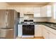 Efficient kitchen with white cabinets, stainless steel appliances, and a sleek gas range for easy cooking at 2536 Lancewood Ln, Lithonia, GA 30058