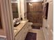 Bathroom featuring a granite countertop, double vanity, tiled shower, and white cabinets at 107 Heatherwood Trce, Acworth, GA 30101