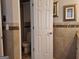Neutral bathroom with mosaic tile accents features a toilet room with built in storage at 107 Heatherwood Trce, Acworth, GA 30101