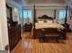 Bedroom with hardwood floors, a four poster bed, shuttered windows and traditional furniture at 107 Heatherwood Trce, Acworth, GA 30101