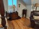 Bedroom featuring hardwood floors, traditional furniture, and bright natural light from shuttered windows at 107 Heatherwood Trce, Acworth, GA 30101