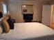 Cozy bedroom featuring a comfortable bed, mounted TV, and a doorway, with neutral-toned walls at 107 Heatherwood Trce, Acworth, GA 30101