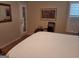 Tranquil bedroom featuring a white bed, shuttered window, and framed artwork at 107 Heatherwood Trce, Acworth, GA 30101