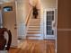 Welcoming foyer featuring hardwood floors, staircase and elegant front door that offers a warm arrival at 107 Heatherwood Trce, Acworth, GA 30101