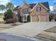 Charming two-story brick home featuring a two-car garage, well-manicured lawn, and traditional architectural details at 107 Heatherwood Trce, Acworth, GA 30101