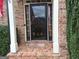 Inviting entryway with brick columns framing the doorway and a glimpse of the home's interior at 107 Heatherwood Trce, Acworth, GA 30101