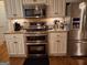 Updated kitchen showcasing stainless steel appliances and white cabinetry at 107 Heatherwood Trce, Acworth, GA 30101