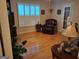 Living room featuring hardwood floors, shutters, and a comfortable leather chair at 107 Heatherwood Trce, Acworth, GA 30101