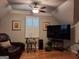 Living room with high ceilings, hardwood floors, a leather chair and a large tv at 107 Heatherwood Trce, Acworth, GA 30101