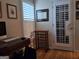 Bright office space with natural light coming through plantation shutters and a decorative wine rack at 107 Heatherwood Trce, Acworth, GA 30101