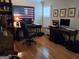 Home office featuring hardwood floors, two desks, a comfortable office chair, and natural light at 107 Heatherwood Trce, Acworth, GA 30101